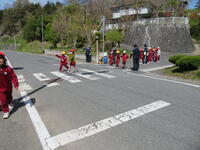 1年生と2年生が協力して横断歩道を渡っています。